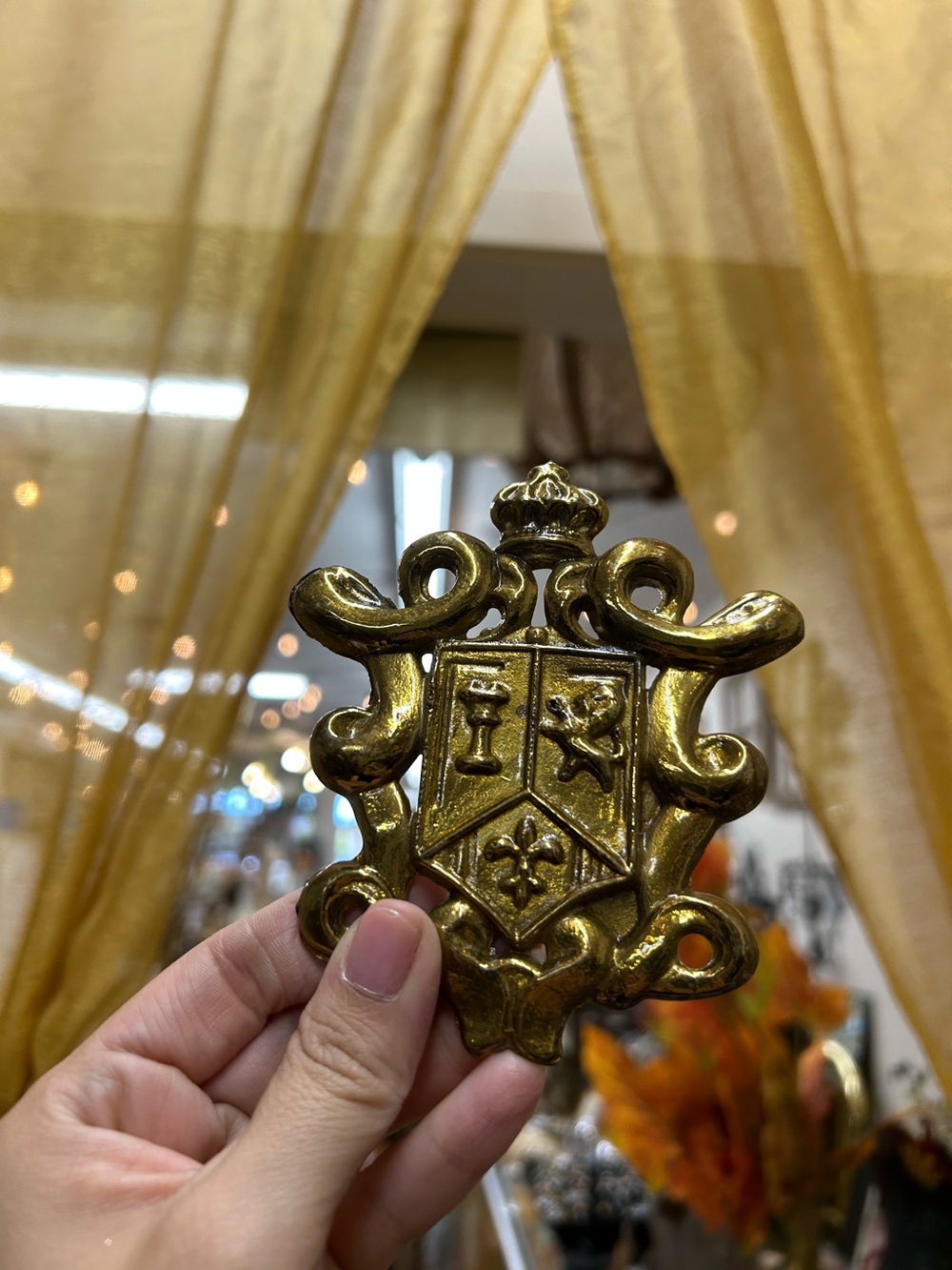 vintage gold-toned or brass-plated metal coat of arms or family crest decorative